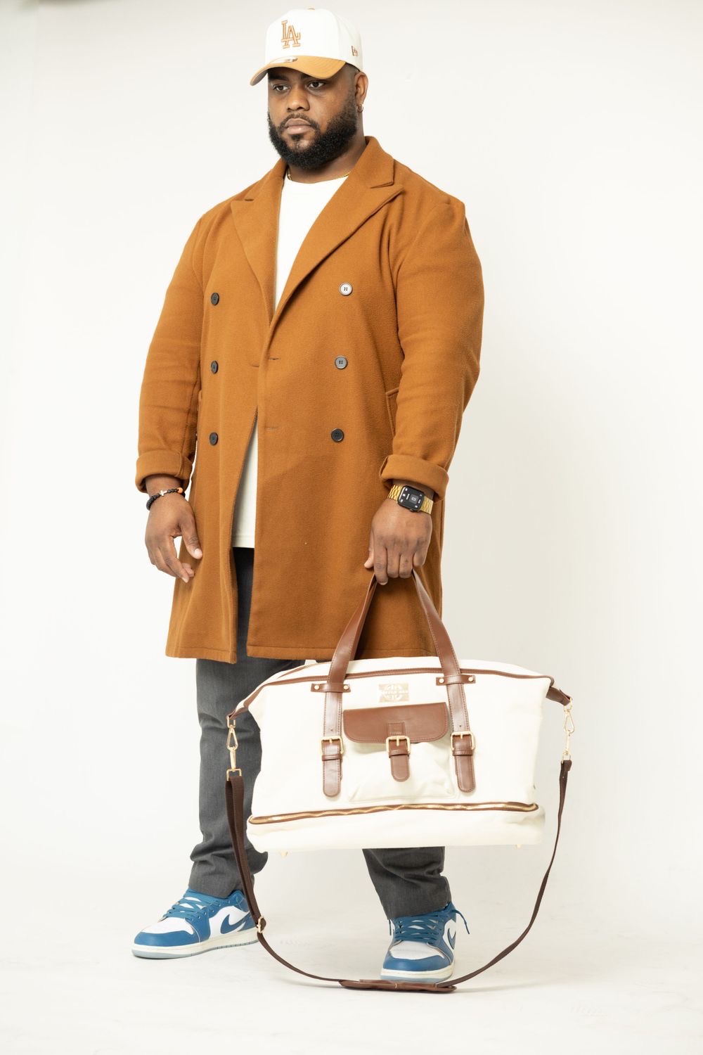 The Daddy Duffle — carried in studio by a dad in a camel overcoat